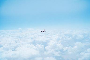 Airplane_Flying_Above_Clouds.jpg