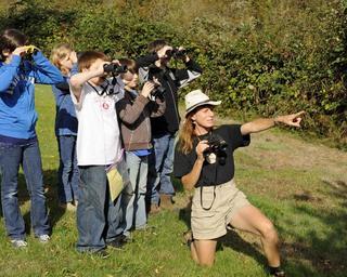 Students learn about birding and how to use binoculars from a employee.jpg
