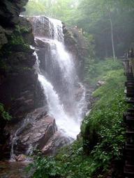 Waterfall in the forest with rocks.jpg