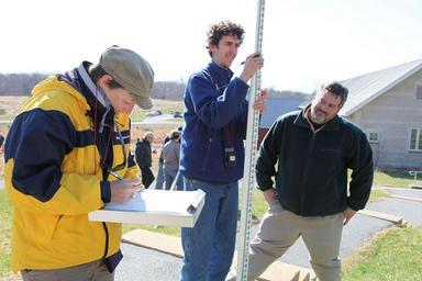 Students attending course and practice using a surveyor rod for mapping profiles of various habitat features.jpg
